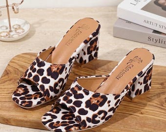 Elegantes sandalias de tacón con estampado de leopardo en tonos marrón y negro. ¡Estilo y comodidad se combinan en una puntera cuadrada, textura de ante y un cómodo tacón de bloque!