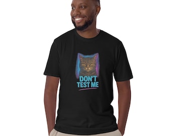 May include: Black t-shirt featuring a cat illustration with the text "DON'T TEST ME" in blue and pink. The cat has yellow eyes and a stern expression. The design is set against a gradient background.
