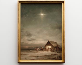 May include: A framed print depicting a nighttime scene with a bright star shining over a humble dwelling. Figures on camels approach the structure, with other figures gathered nearby. The artwork is framed in a gold-colored frame.