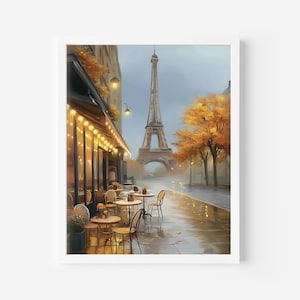 May include: A framed watercolor painting of a Parisian street scene. The Eiffel Tower is in the background, with a cafe in the foreground. The cafe has small tables and chairs, and is lit with string lights. The street is wet, and the trees have autumn foliage.