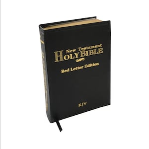 May include: A black Bible with gold lettering, featuring the text "New Testament Holy Bible Red Letter Edition" and "KJV". A black ribbon bookmark is visible.