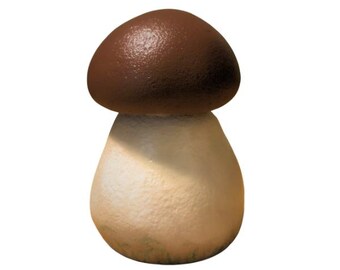 May include: A ceramic mushroom figurine with a brown cap and a cream-colored stem. The mushroom has a textured surface and is set against a white background. This decorative item is suitable for home decor.