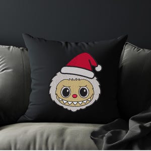 Black throw pillow with cute Santa hat kawaii monster embroidery design – Christmas-themed cartoon embroidery home decor mockup