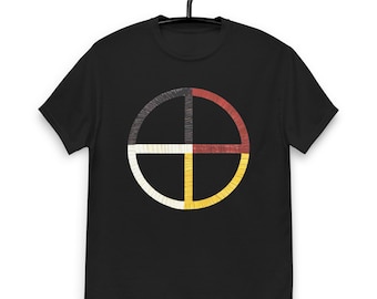 May include: Black t-shirt featuring a circular design divided into four sections. The sections are colored black, red, white, and yellow, with a stitched appearance. The design is centered on the front of the shirt.
