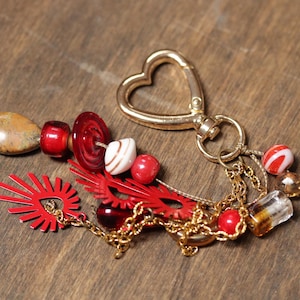 Accesorios de cuero con clip para bolsos, decoración para bolsos, estilo bandolera, colgante bohemio con cuentas con clip para bolsos, color rojo y dorado.