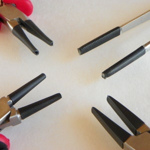 May include: Four jewelry making tools, including a pair of red-handled pliers with black-tipped jaws, a pair of pliers with black-tipped jaws, a pair of tweezers with black-tipped jaws, and a pair of tweezers with black-tipped jaws.