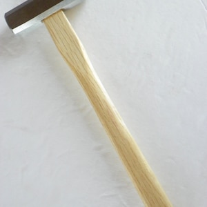 May include: A wooden-handled hammer with a silver head. The hammer is on a white background.