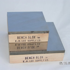 May include: Two rectangular bench blocks. Each block has a light gray top and a wooden base. The text "BENCH BLOK TM K.H. LEE SUPPLY CO." is printed on the wooden base. The date "05.13.2008" is in the bottom right corner.