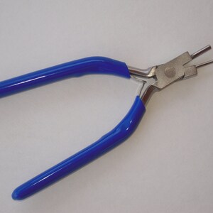 May include: Blue handled pliers with a silver metal head and two prongs. The pliers are used for jewelry making.