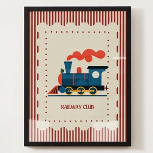 May include: Framed print featuring a blue train with red accents and orange smoke, set against a cream background with a decorative border. The words "RAILWAY CLUB" are printed below the train. The frame is black.