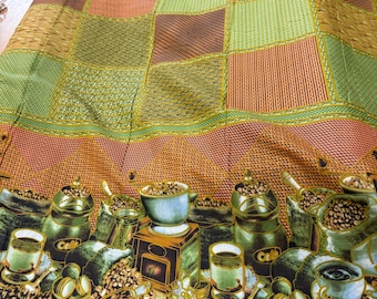 May include: A colorful fabric with a coffee theme. The top portion features a patchwork design in shades of green, orange, and brown. The bottom border showcases coffee cups, beans, and grinders in a detailed illustration. The fabric has a textured appearance.
