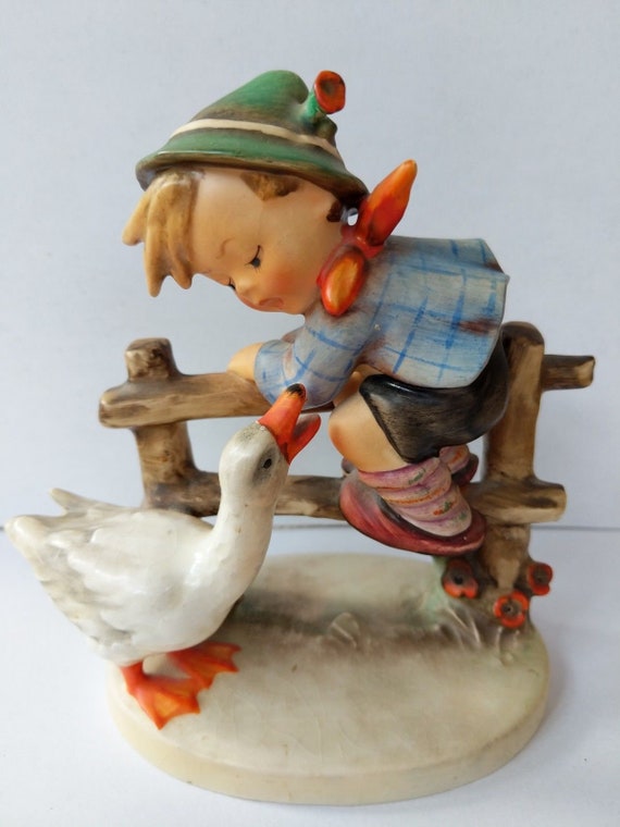 hummel boy on fence with goose
