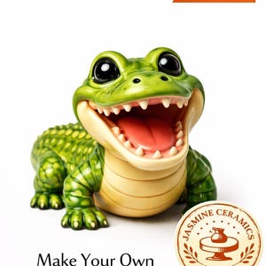 May include: A ceramic alligator figurine with a wide open mouth, showcasing a pink interior. The alligator is green with a textured back and yellow underbelly. The image includes text that says "Make Your Own Ceramic Alligator" and "Digital Download".