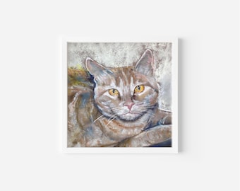 May include: A square, framed artwork featuring a detailed pastel portrait of a cat. The cat has brown and tan fur, yellow eyes, and a pink nose. The artwork is set against a soft, textured background.