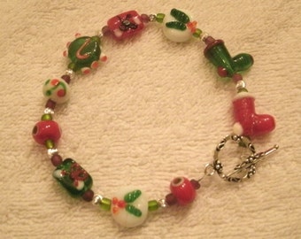 Holiday Lampwork Glass Bead Santa Boot and Holly Leaf Red and Green Bracelet