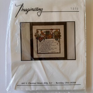 May include: A cross-stitch kit in a clear plastic package. The kit features a framed cross-stitch with the text "Rules of Collecting" and a decorative border. The package is labeled "Imaginating" and includes the address 645 S. Chestnut Street, Bldg. A-1, Ravenna, Ohio 44266.