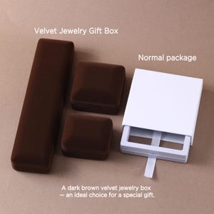 May include: Three dark brown velvet jewelry boxes in rectangular and square shapes, alongside a white cardboard sliding drawer package with a white ribbon pull tab. The text Velvet Jewelry Gift Box and Normal package appear above.