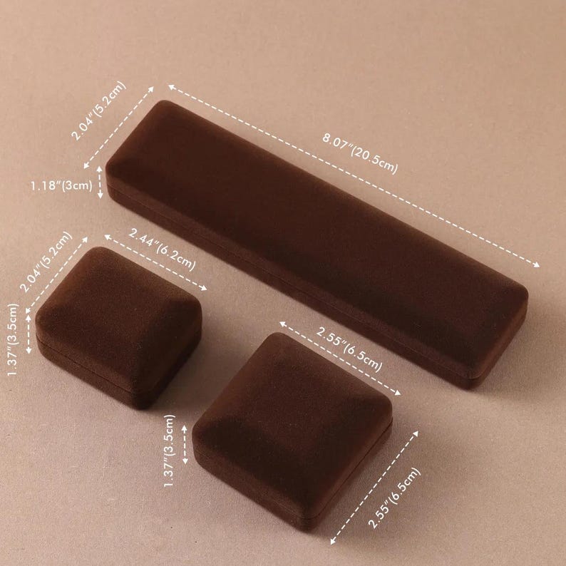 May include: Three brown velvet jewelry boxes of varying shapes and sizes. One long rectangular box measures 8.07 inches by 2.04 inches by 1.18 inches. Two square boxes measure 2.44 inches by 2.04 inches by 1.37 inches and 2.55 inches by 2.55 inches by 1.37 inches.