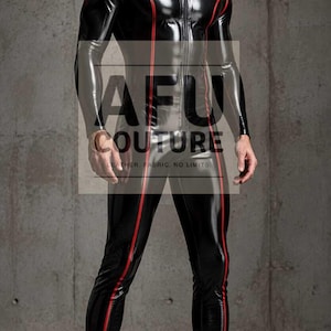 May include: A black long-sleeved jumpsuit with a glossy finish, featuring a front zipper closure and thin red piping accents running vertically along the torso and legs. The text AFU COUTURE LEATHER. FABRIC. NO LIMITS is printed on the front.