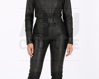 May include: A black leather shirt with two chest pockets and matching black leather pants. The shirt has a collared neckline and button closures. The pants are fitted with a classic five-pocket design. The outfit is sleek and stylish.