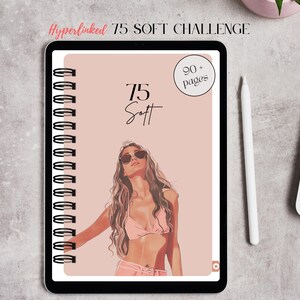 May include: A digital notebook with a spiral binding, featuring a woman in sunglasses and swimwear. The cover is light pink with the text "75 Soft Challenge" and "90+ pages". A white stylus and laptop are next to the notebook.