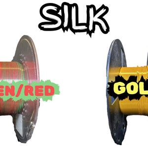 May include: Image of two spools of silk thread. One spool is filled with green and red thread, labeled "GREEN/RED". The other spool is filled with gold thread, labeled "GOLD". The word "SILK" is above the spools.