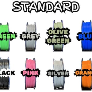 May include: A collection of spools of filament in various colors, including wood, green, grey, olive green, blue, yellow, white, black, pink, silver, orange, and red. The word "STANDARD" is at the top.