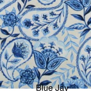 May include: A fabric pattern featuring a white background with intricate blue paisley motifs, floral elements, and leafy vines. The design includes various shades of blue, ranging from light sky blue to deep navy, with the text Blue Jay at the bottom.