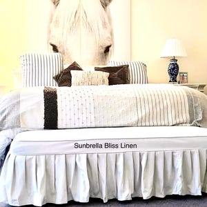 Custom bench slipcover with pleated skirt and piping