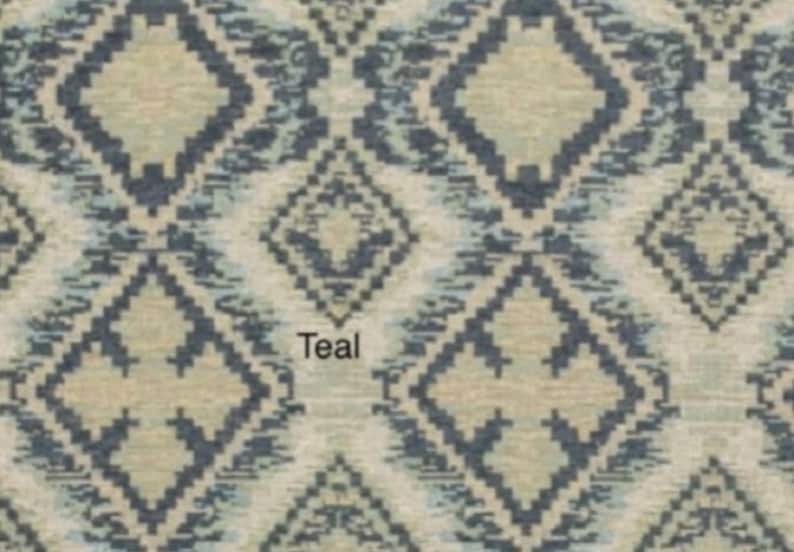 May include: A fabric swatch featuring a repeating geometric diamond pattern in shades of dark teal, light blue, and beige. The word Teal is printed in black text in the center of the image, overlaying the intricate woven textile design.