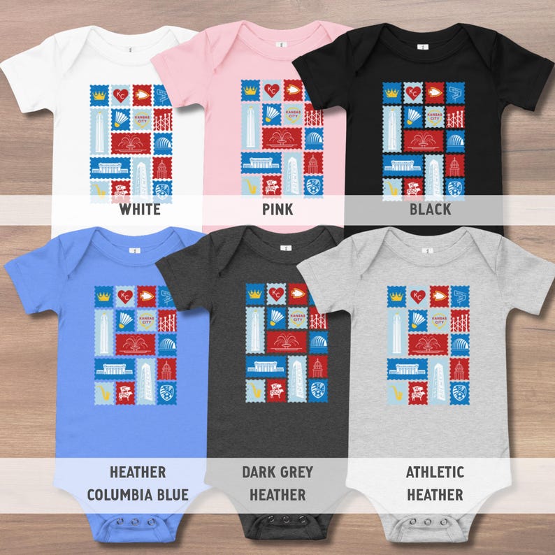 May include: A collection of six baby onesies in various colors: white, pink, black, heather Columbia blue, dark grey heather, and athletic heather. Each onesie features a colorful stamp-like design with the text "Kansas City".