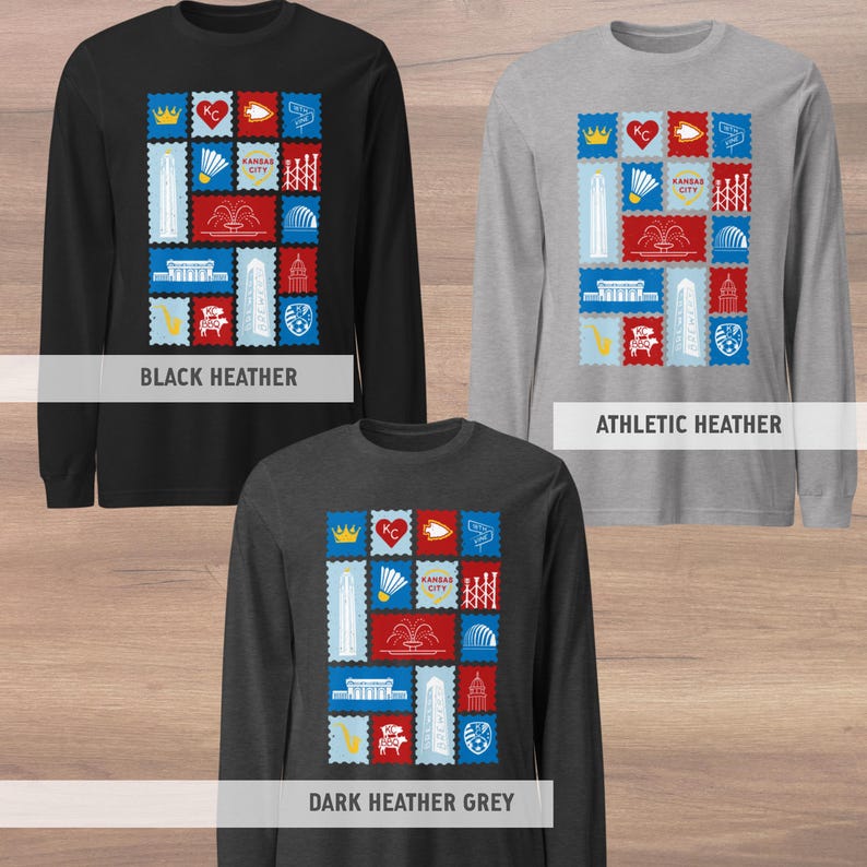 May include: Long-sleeve shirts in black, athletic heather, and dark heather grey. Each shirt features a colorful graphic of postage stamp designs with Kansas City landmarks and the text "Kansas City".