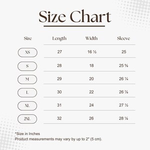 May include: A size chart with measurements in inches for XS to 2XL. The chart includes length, width, and sleeve measurements. The text "Size Chart" is at the top. The bottom of the chart states "Size in Inches" and "Product measurements may vary by up to 2" (5 cm)."
