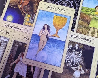 May include: A collection of tarot cards including the Ace of Cups, Five of Pentacles, Page of Cups, Judgment, and Nine of Swords. The Ace of Cups card features a figure emerging from blue ocean waves holding a large golden chalice.
