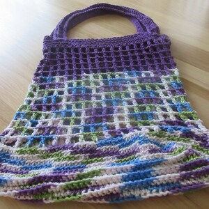 May include: A crocheted purple, green, blue, and white tote bag with a mesh design.