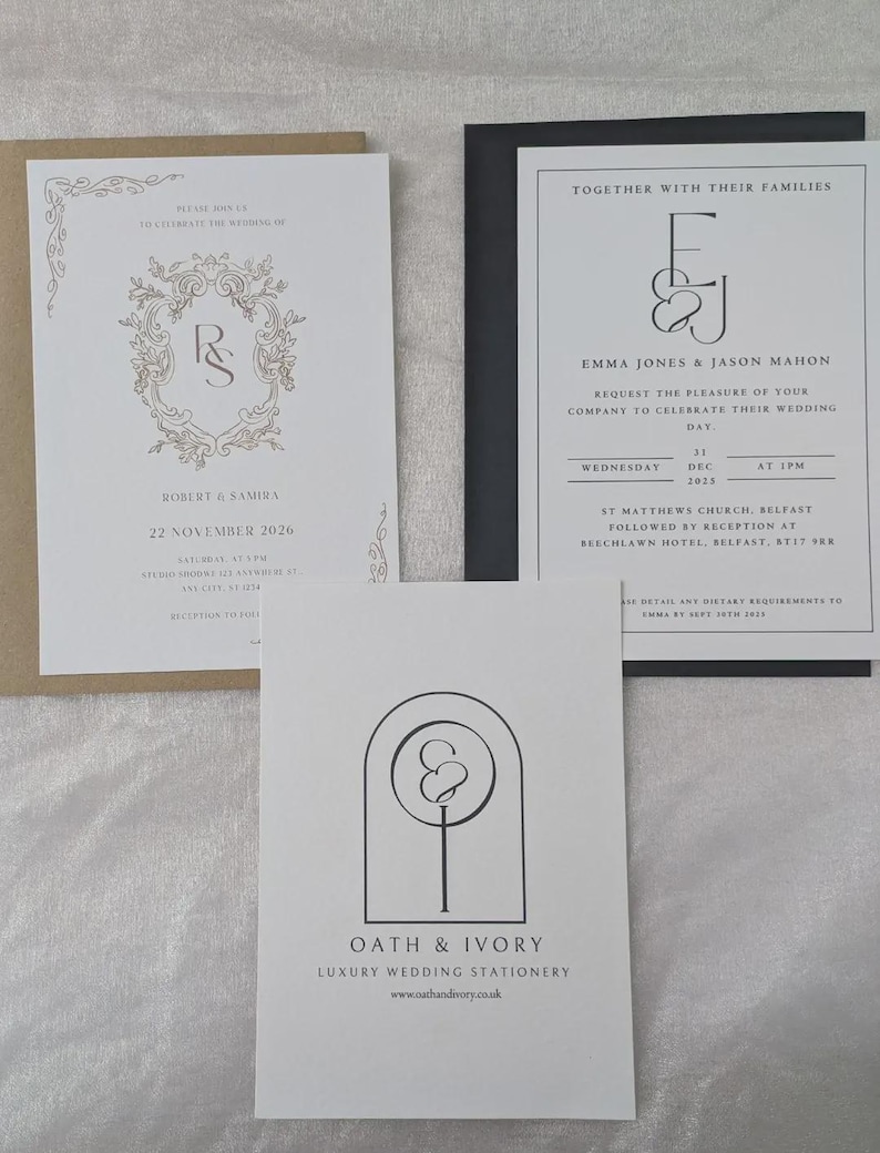 May include: Three wedding stationery cards. One white card with gold ornate frame and text Robert & Samira 22 November 2026 in a tan envelope. One white card with black text E&J Emma Jones & Jason Mahon in a black envelope. One white card with Oath & Ivory logo.