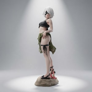May include: A standing figurine of a character with short white hair and a black eye covering. The figure wears a black crop top, a green sarong with a floral pattern, and black sandals. It stands on a textured rock base with a small red crab.