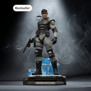 May include: A detailed figurine of a character in tactical gear, holding a gun. The figure is predominantly gray and black, with a black headband. It stands on a blue, icy base, with a "Bestseller" label in the top left corner.