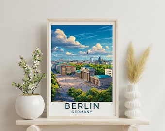 May include: A framed travel poster featuring a vibrant illustration of the Brandenburg Gate in Berlin, Germany, under a bright blue sky with fluffy white clouds. The text BERLIN GERMANY is printed in dark blue at the bottom of the artwork.
