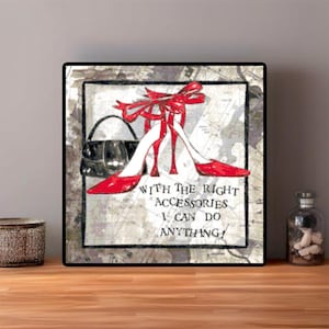 May include: Square framed art print featuring a pair of red high heels with a matching bow, a black handbag, and the text "With the right accessories I can do anything!" on a map-like background.