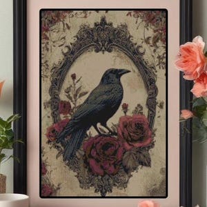 May include: Framed artwork featuring a black crow perched on burgundy roses within an ornate oval frame. The background has a vintage, floral design. The frame is black with a pink mat.