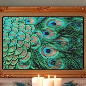 May include: A framed print featuring a close-up of peacock feathers in shades of green, teal, and brown. The artwork is displayed in a gold ornate frame. Lit candles flank the framed print, creating a warm ambiance.