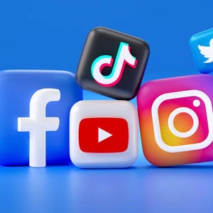 May include: A collection of 3D rendered social media icons, including Facebook, TikTok, YouTube, Instagram, and Twitter, against a blue background. The icons are square-shaped with rounded corners, each displaying its respective logo in vibrant colors.