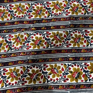May include: Floral fabric with a repeating pattern of stylized flowers in gold, red, and navy blue on a white background. The design includes horizontal stripes with floral and geometric elements.