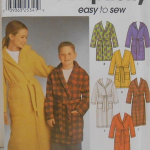 May include: Simplicity sewing pattern for robes. The image shows a woman and a boy wearing robes. The pattern includes various robe styles, including a plaid robe, a yellow robe, and a purple hooded robe. The text "easy to sew" is visible.