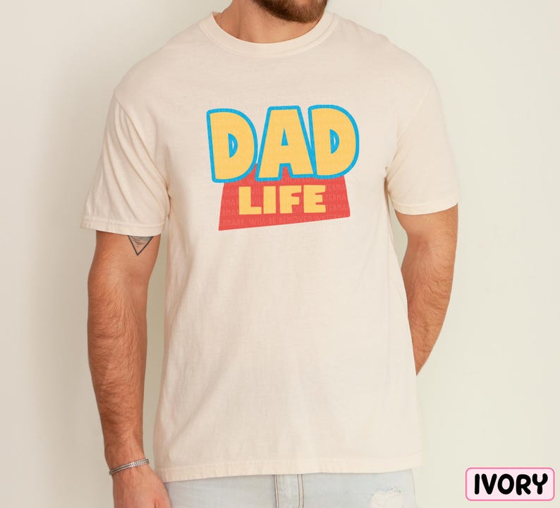 A man wearing a white t-shirt with the text "DAD LIFE" printed on it.