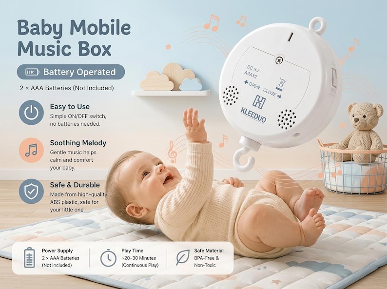 May include: A white, circular battery-operated baby mobile music box by KLEEDUO. The device features a central hook, two speaker grilles, and a battery compartment requiring 2 x AAA batteries. Text on the unit includes DC 3V, AAAx2, and OPEN CLOSE.