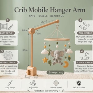 May include: A wooden crib mobile hanger arm with a clamp base, featuring a hanging mobile with a plush gray elephant, stars, clouds, leaves, and a moon. The arm measures 32.7cm in length, 32cm in height, and the base is 6.4cm by 6cm.