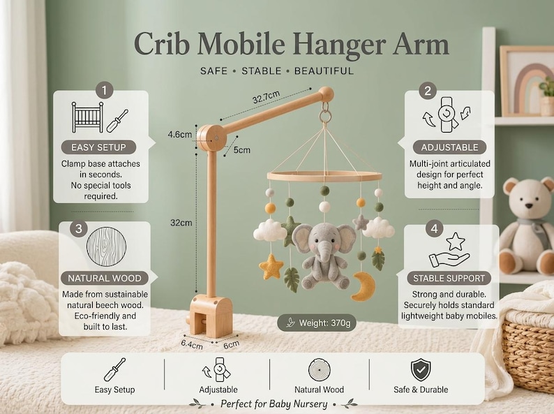 May include: A wooden crib mobile hanger arm with a clamp base, featuring a hanging mobile with a plush gray elephant, stars, clouds, leaves, and a moon. The arm measures 32.7cm in length, 32cm in height, and the base is 6.4cm by 6cm.