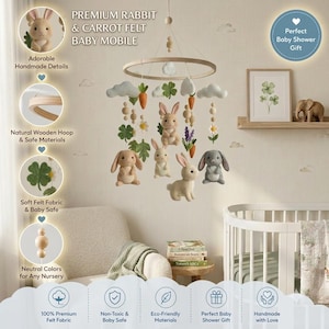 May include: A baby mobile featuring a circular wooden hoop suspended with felt elements including four rabbits in shades of brown and gray, orange carrots, white clouds, green four-leaf clovers, white flowers, and small wooden beads on strings.